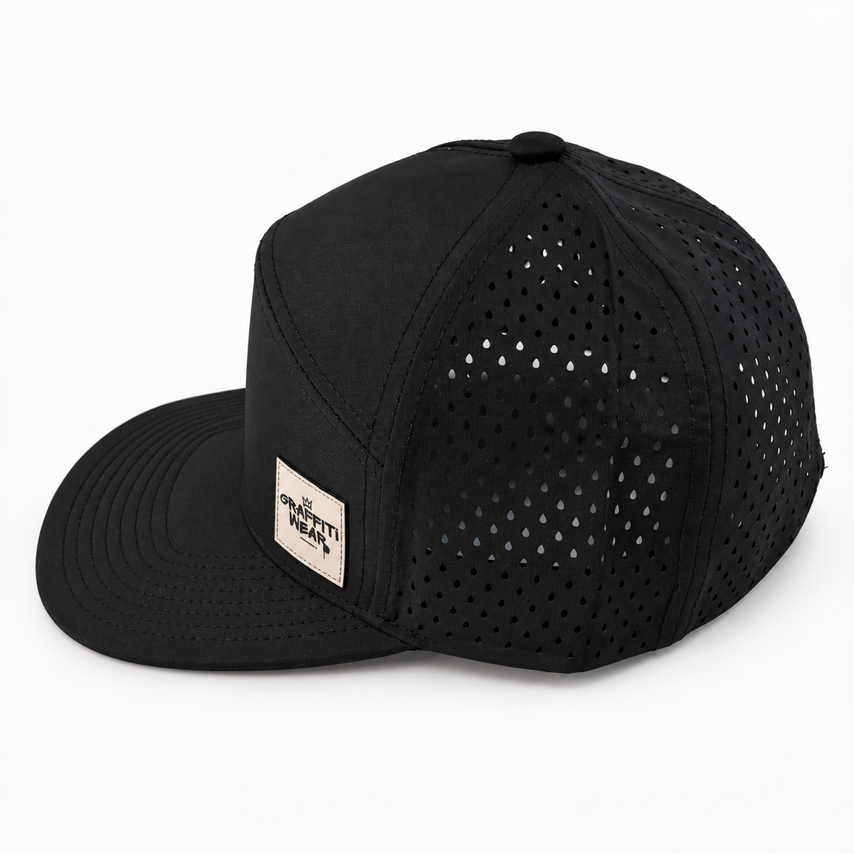 Side view of Graffiti Wear black 7-panel snapback with tan leather patch and laser-perforated back panels