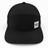 Graffiti Wear all-black 7-panel snapback hat, front view with flat brim and tan leather patch