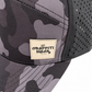 Close-up of tan leather Graffiti Wear patch on black camo snapback with perforated mesh